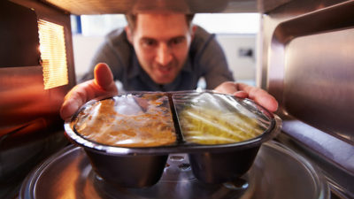 A Muggle microwaving a "TV Dinner."